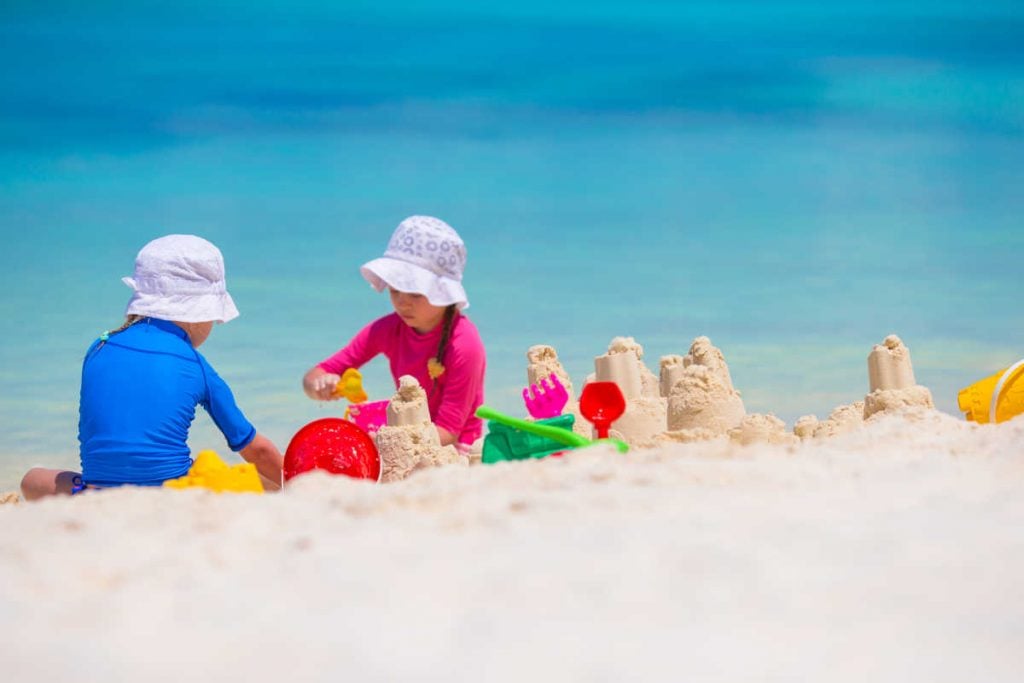 Kids building sandcastle beach
