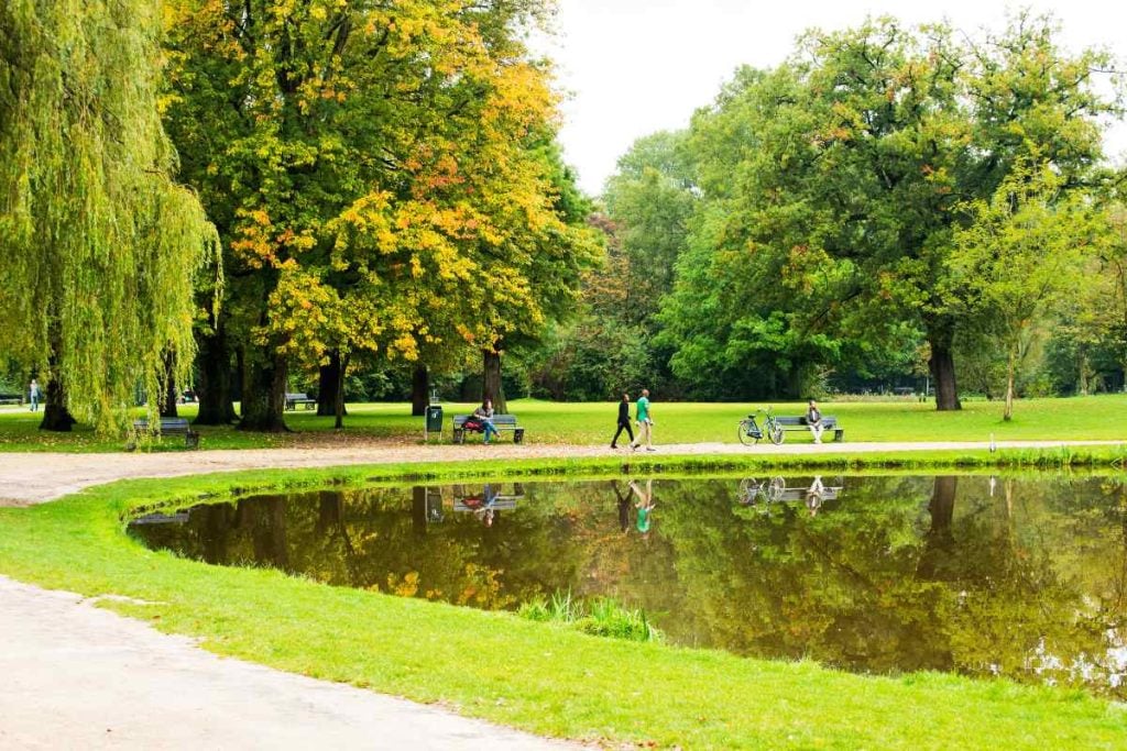 View of a pond and biking trails in Vondelpark, Amsterdam.